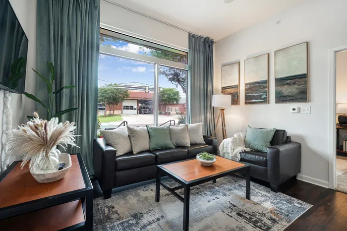 living room in model unit witth couches, chairs, and tables. campus crossings on highland baton rouge