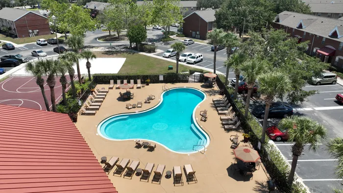 pool area with lounge chairs and umbrellas