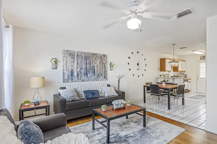 model unit living room furnished with chair and couches, coffee table and end table.