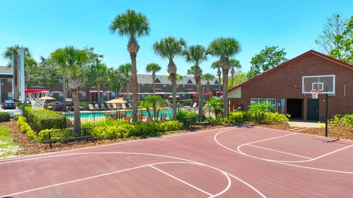 sports court with basketball net and clubhouse