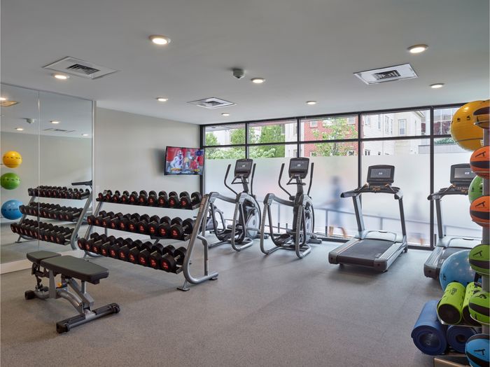the simon at founders row. fitness center with elliptical, treadmills, free weights, and medicine balls.