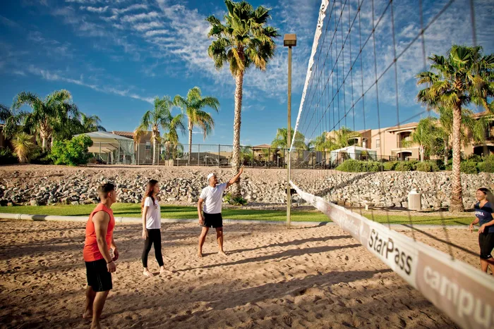 campus crossings at star pass volleyball court with three players