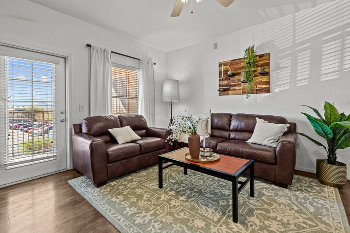 campus crossings at star pas model unit living area with couches and coffee table
