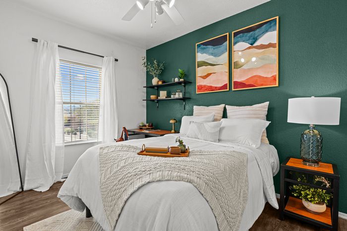 campus crossings at star pass model unit bedroom with end table and desk.