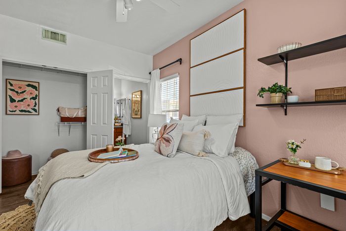 campus crossings at star pass model unit bedroom with desk, closet, and shelving.