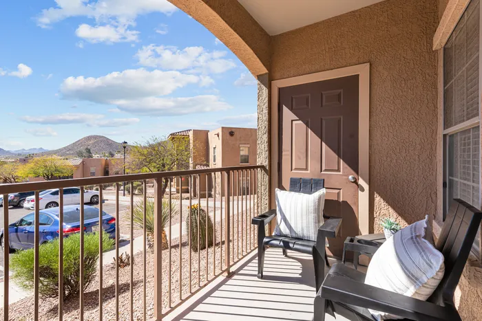 campus crossings at star pass model unit patio with chairs and outdoor pilows