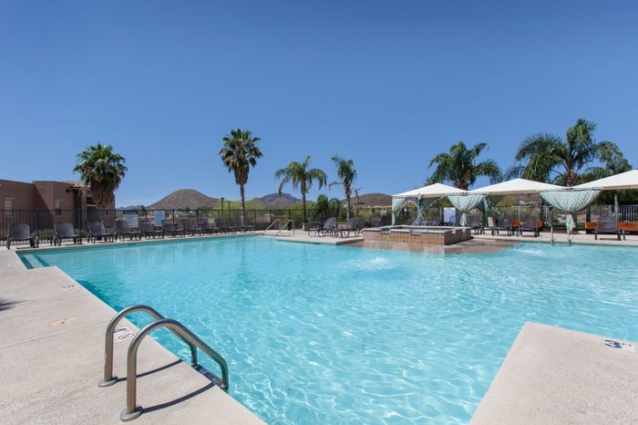 campus crossings at star pass pool area with cabanas and lounge chairs