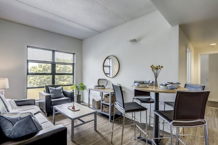 campus crossings at college row model unit living area with couch, chair and coffee table lancaster pa franklin & marshall