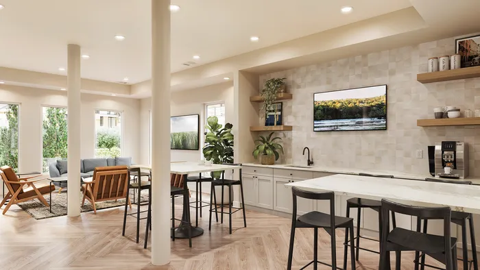 renovated resident lounge with coffee machine, counter top, and chairs.