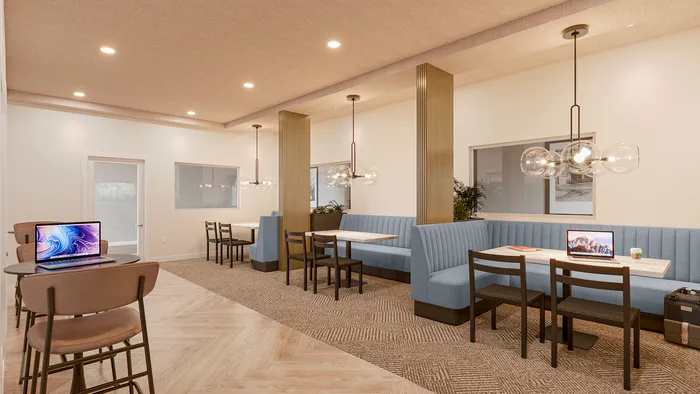 campus crossings briarcliff renovated resident lounge with booths, chairs, and tables.