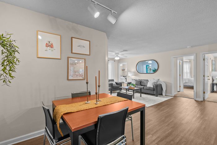 abbey west athens georgia model unit dining area with dining room table and chairs.