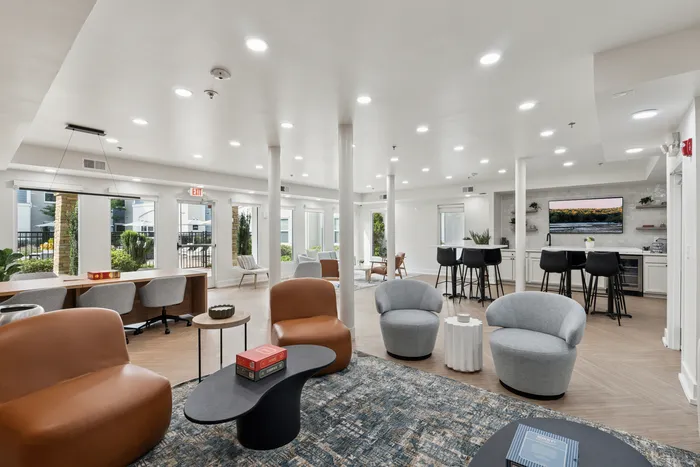 renovated resident lounge seating area with couches, and chairs.