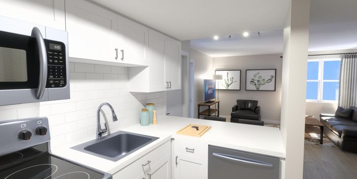 Modern open-plan kitchen with sleek white cabinetry, stainless steel appliances, and inviting living area. Bright and airy space with large windows and stylish decor.