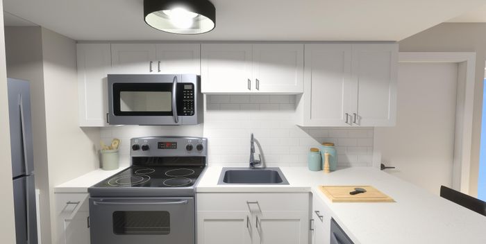Modern kitchen with sleek gray appliances, white cabinetry, and elegant fixtures.