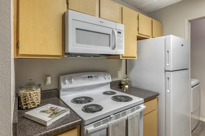 Charming kitchen space featuring modern appliances, sleek countertops, and warm cabinetry.