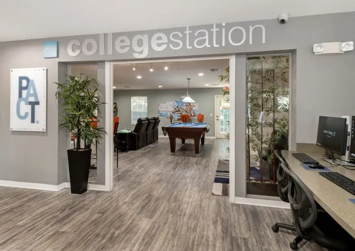 clubhouse entrance with computer stations and pool table orlando student housing