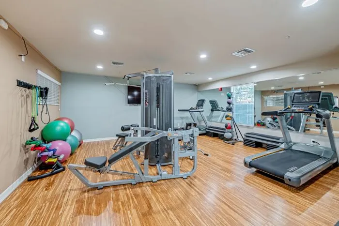 fitness center with weight machines, treadmill, and free weights orlando student housing