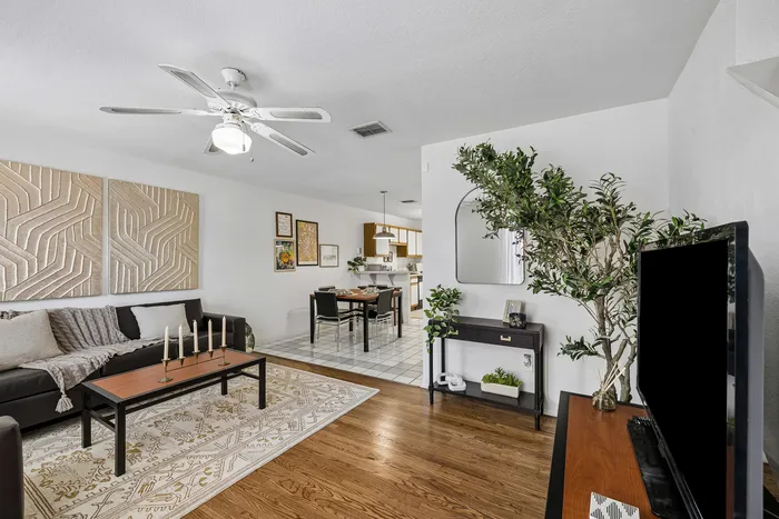 Inviting apartment interior featuring a cozy living room with stylish decor, an elegant dining area, and a modern kitchen, offering a perfect blend of comfort and sophistication.