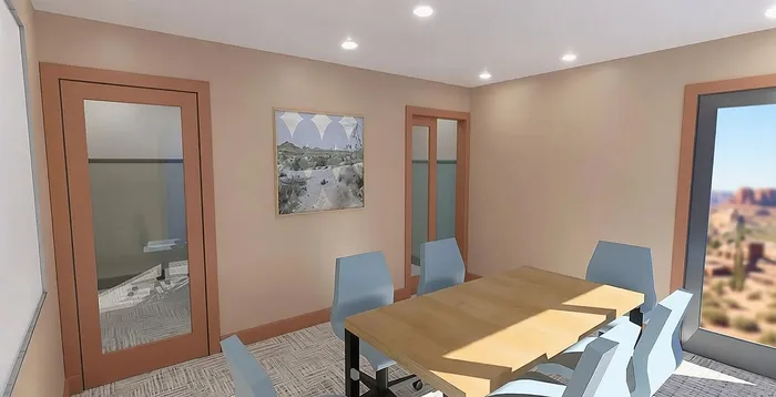 Bright and modern conference room with sleek glass doors, elegant artwork, and a stunning desert view.