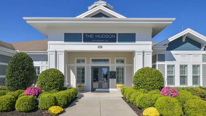 Elegant entrance of The Hudson in Statesboro, GA, featuring manicured landscaping and classic architectural design.