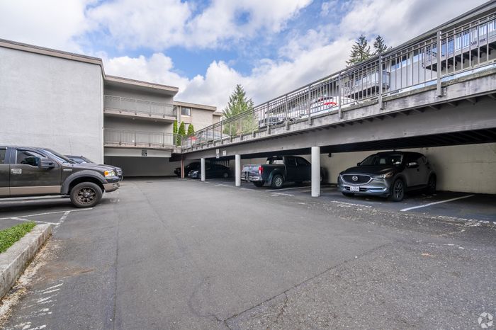 Modern apartment complex with spacious covered parking area, offering convenient and secure vehicle storage in a beautifully maintained neighborhood.