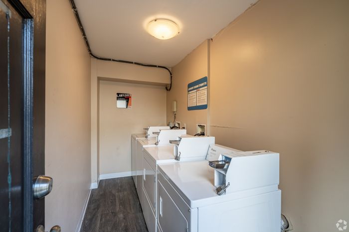 Charming apartment laundry room equipped with modern washers and dryers for convenient living.