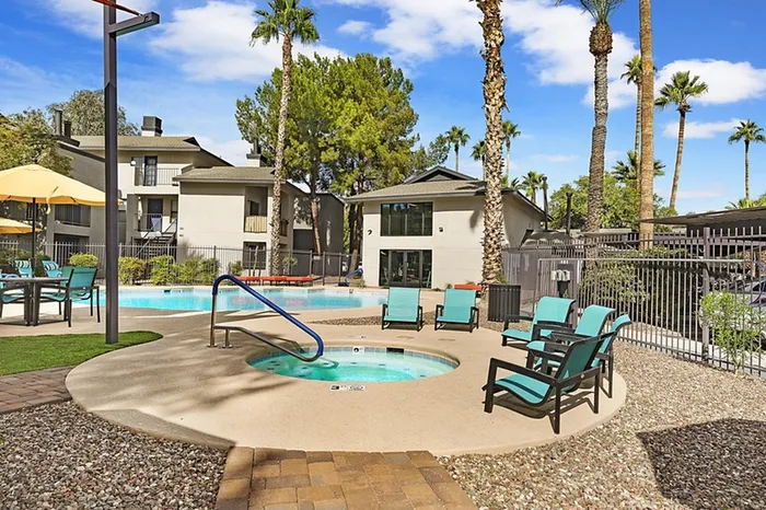 Resort-style pool and hot tub with loungers at 225 North in Tucson, Arizona
