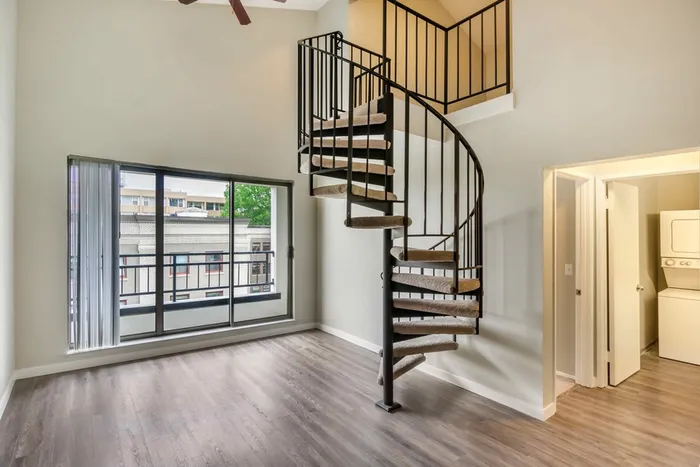 Spacious Living Room View with Spiral Staircase at Avanti in Seattle, WA