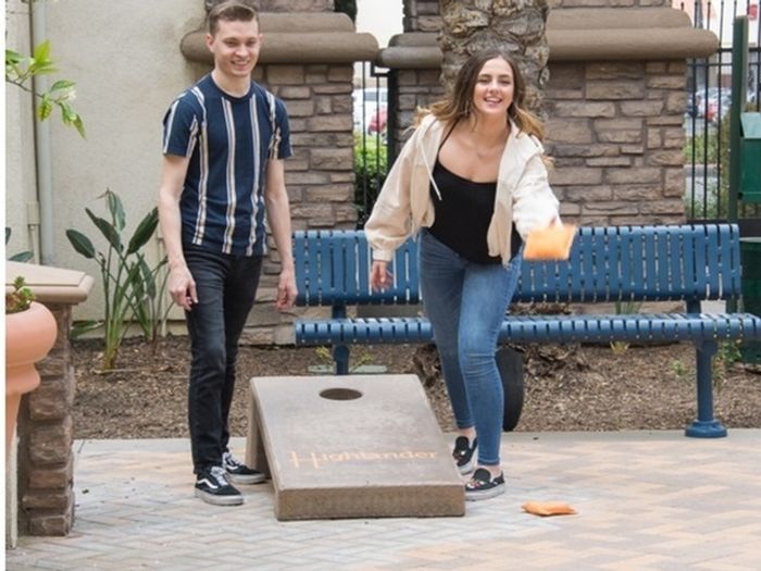 Three courtyards at Highlander at North Campus in Riverside, California featuring ping pong, corn hole, and a fire pit