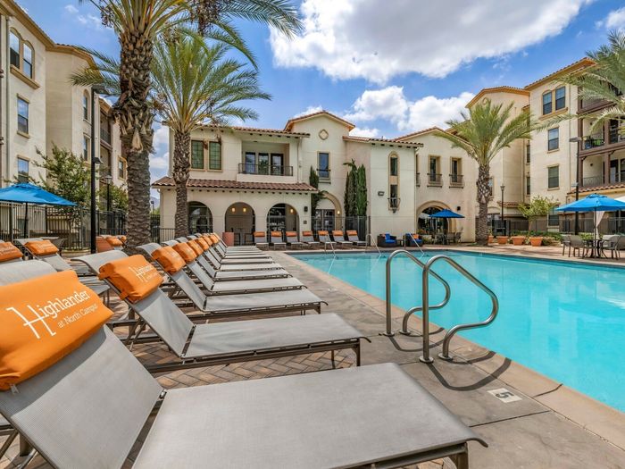 Resort-style pool and Lounge Chairs at Highlander at North Campus in Riverside, California