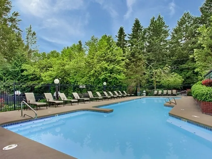 Heated outdoor pool with lounge area at Greystone Meadows apartment community in Federal Way WA