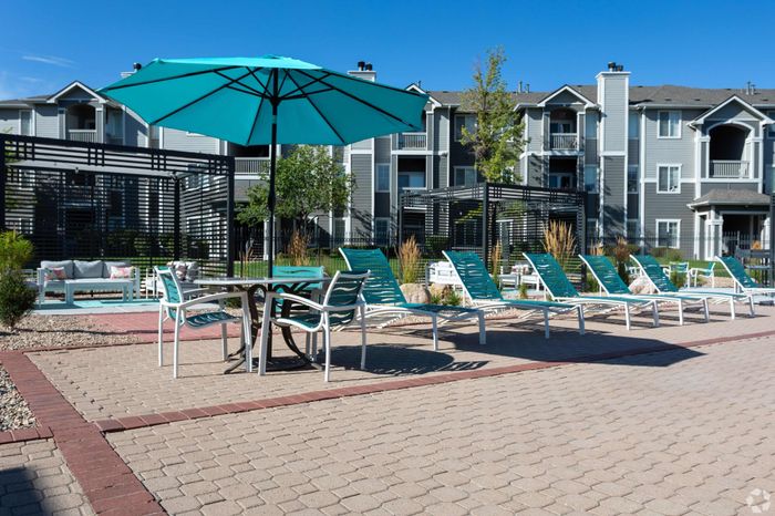 Resort-style Pool and Lounge Chairs at Pinnacle Mountain View apartments in Clearfield, UT