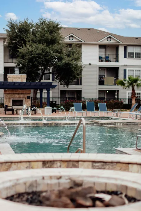 Resort-style pool and fire pit outdoor area at The Zone student apartments near Texas A&M University in College Station TX
