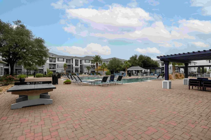 Table tennis and resort-style pool at The Zone student apartments near TAMU in College Station Texas