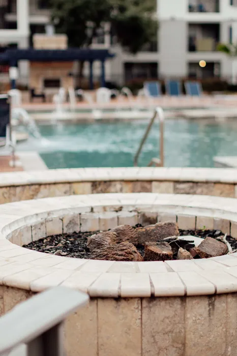 Fire pit and resort-style swimming pool at The Zone student apartments near TAMU in College Station Texas