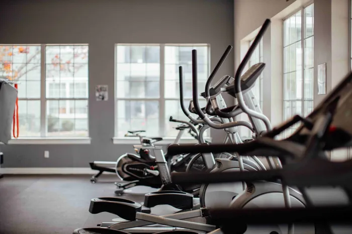 24/7 fitness center with cardio equipment at The Zone student apartments near Texas A&M University in College Station TX