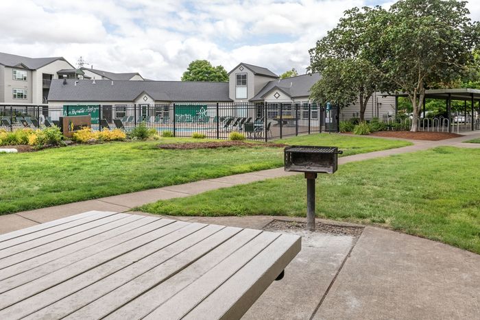 Picnic tables and bbqs at Stadium Park Apartment Community in Eugene, Oregon