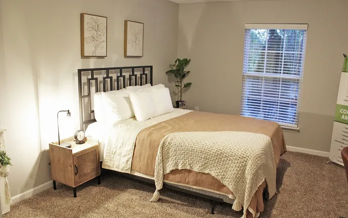 Centennial Ridge bedroom with warm decor, elegant bedframe, and soft lighting.