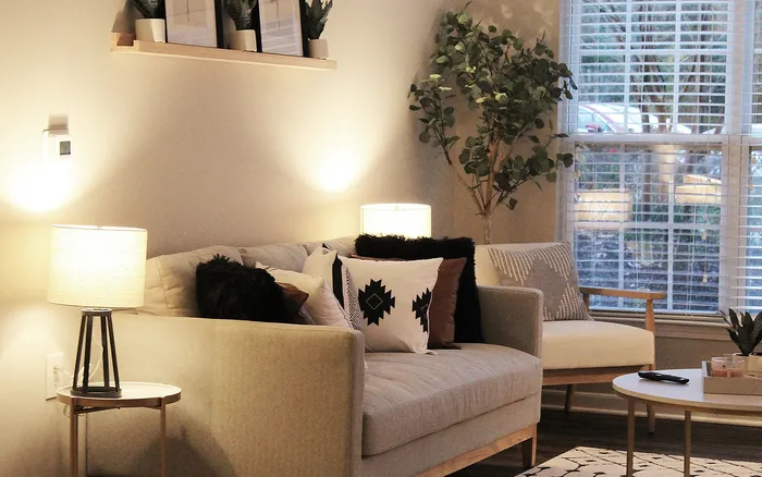 Stylish apartment living room with gray sofa and decorative accents at Centennial Ridge in Raleigh, NC