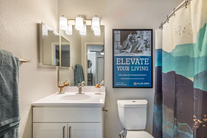 Inviting bathroom with modern fixtures, stylish lighting, and elegant decor at Village Green in Raleigh, North Carolina.