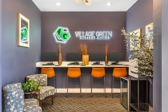 Chic study lounge with computers and contemporary seating at Village Green Student Living.