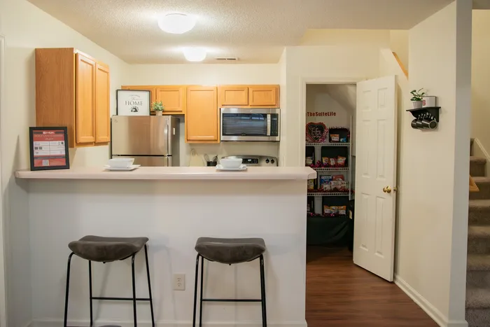 Chic kitchen with stainless steel appliances and a cozy breakfast bar area.