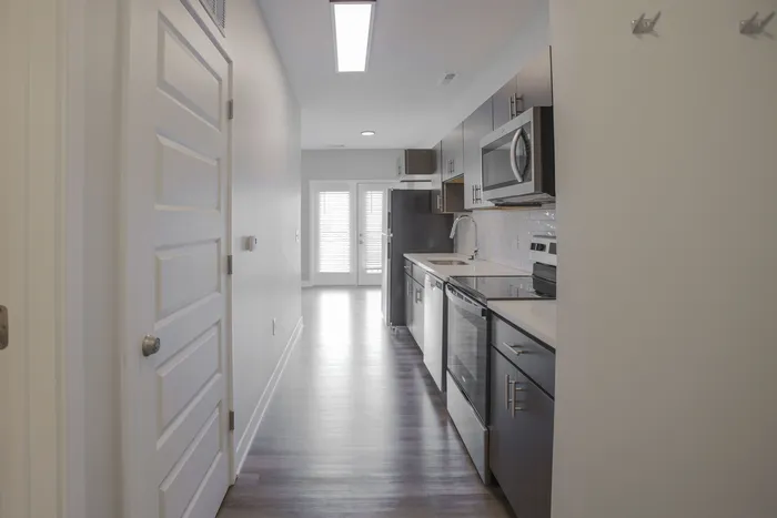 Sleek modern kitchen with stainless steel appliances, elegant cabinetry, and bright natural light. West Lafayette, Indiana. Near Purdue.