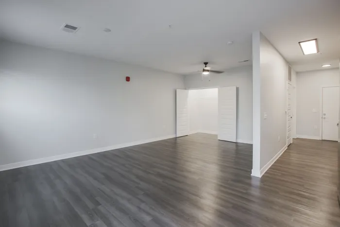 Spacious modern apartment with elegant open floor plan and stylish wood flooring, featuring ample natural light and a versatile living area. West Lafayette, Indiana. Near Purdue.