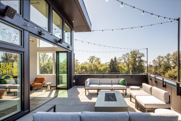 Luxurious apartment balcony featuring modern outdoor seating and scenic views, ideal for serene relaxation and entertaining.