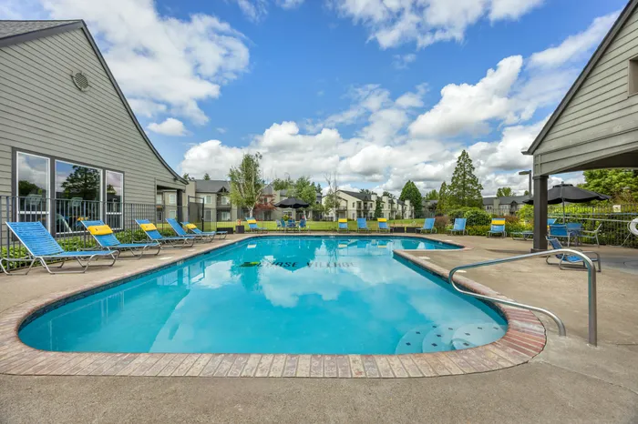 Resort-style outdoor swimming pool in the Gardens area at Chase Village apartments in Eugene OR