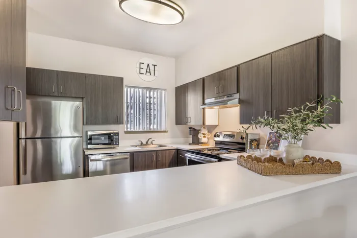 Modern kitchen in model apartment with updated appliances and cabinetry at Chase Village Eugene OR
