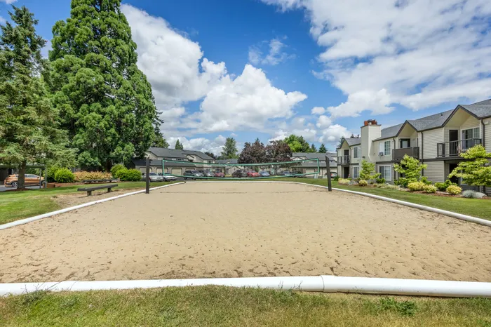 Outdoor sand volleyball court for residents at Chase Village apartments in Eugene Oregon