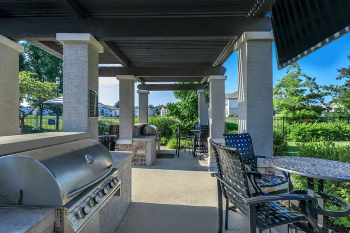 Outdoor lounge and BBQ grilling station with patio seating at Corbin Crossing Overland Park KS