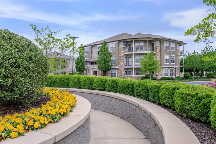 Well-landscaped apartment grounds with lush greenery and private balconies at Corbin Crossing Overland Park KS